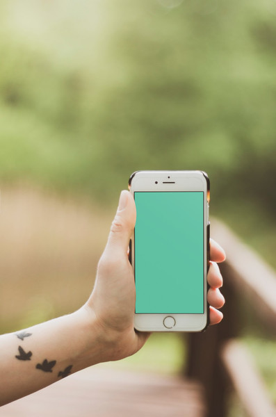 Woman holding white iPhone