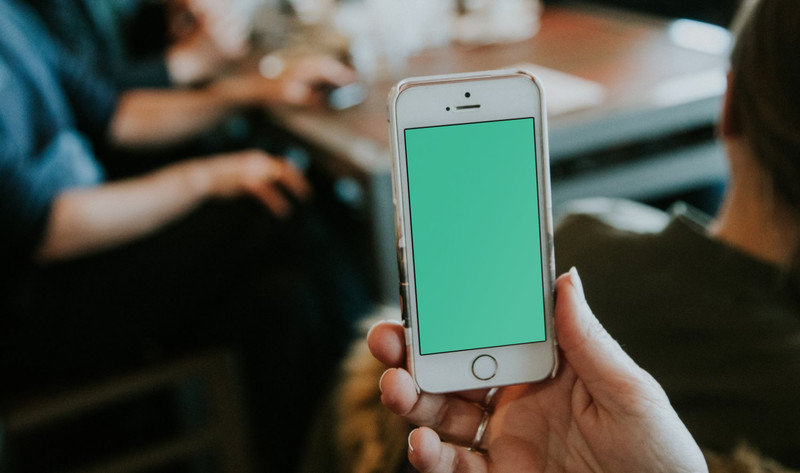 Woman holding white iPhone