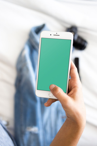 Woman holding white iPhone