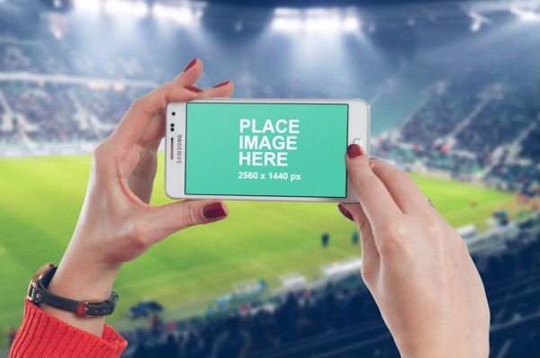 Woman holding Samsung in landscape